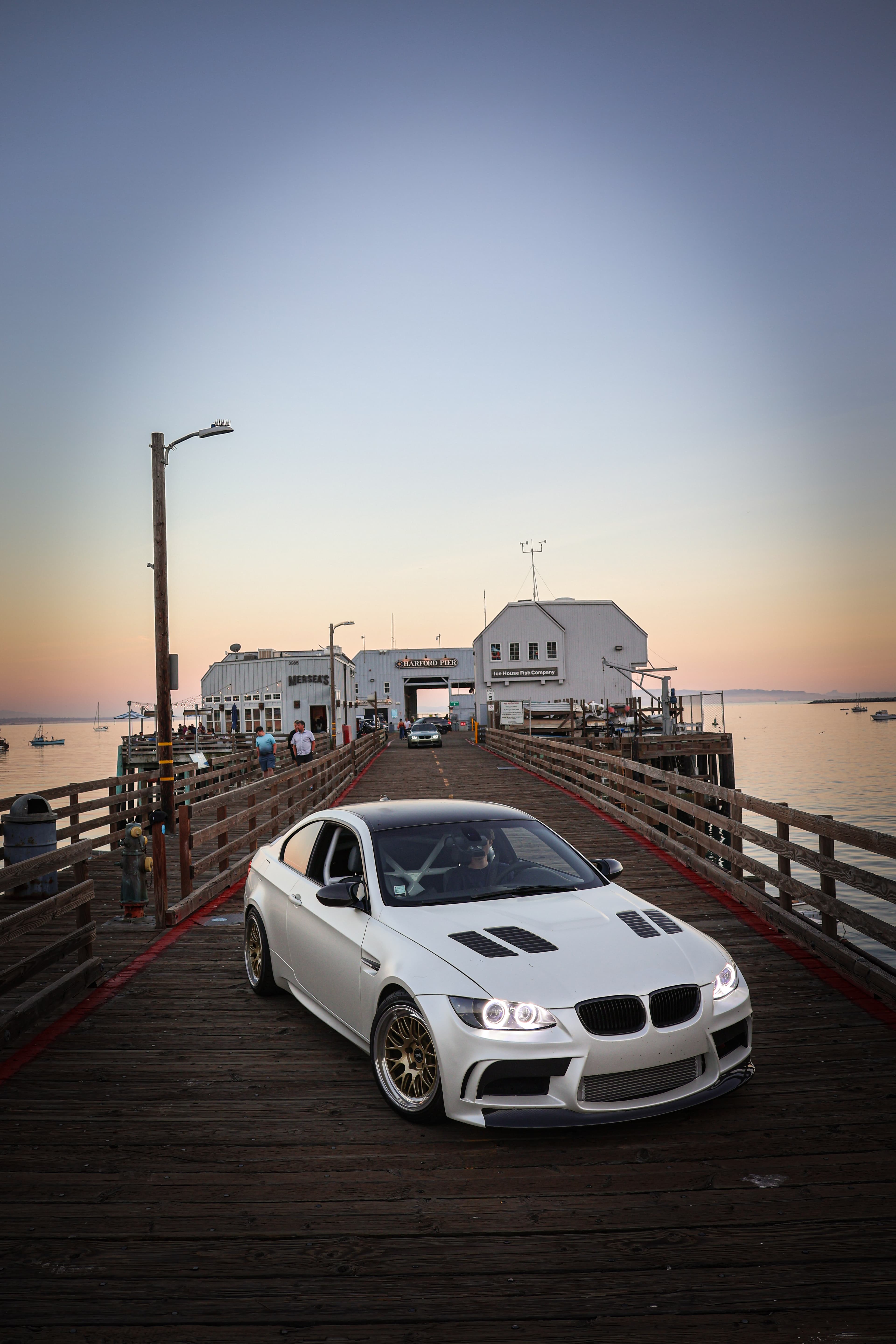 Jared's Alpine White E92 M3 on a pier at sunset