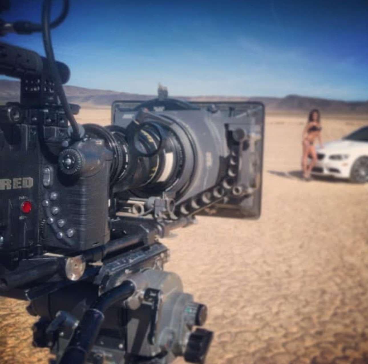 RED Digital Cinema camera filming a model beside Jared's BMW M3
